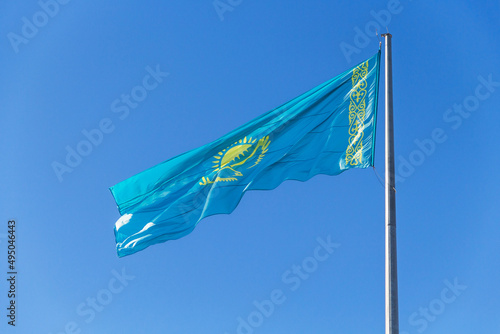 The national flag of the Republic of Kazakhstan (Qazaqstan) flutters in the wind