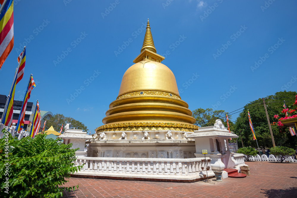 Golden Buddhist stupa close-up on a sunny day. Golden temple in Dambulla