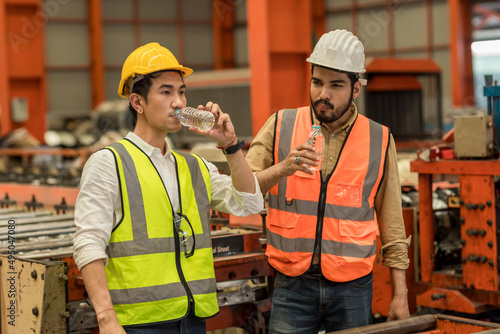 Worker drinking water in factory site.