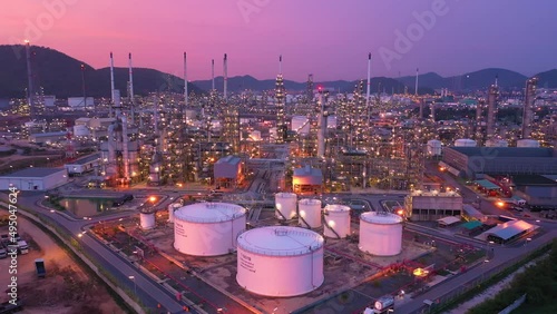 Aerial view at the refinery and oil tank at dusk. Business and petrochemical plants, oil storage tanks and for energy and steel pipes in Twilight time