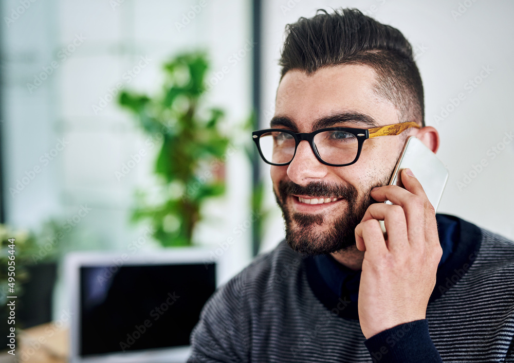 Sure, lets arrange to meet. Shot of a young designer talking on a cellphone in an office. Sure, lets arrange to meet. Shot of a young designer talking on a cellphone in an office.