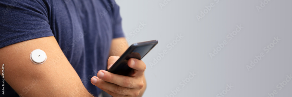 Man Checking Glucose Level On Mobile Phone