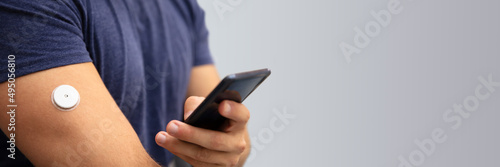 Man Checking Glucose Level On Mobile Phone photo
