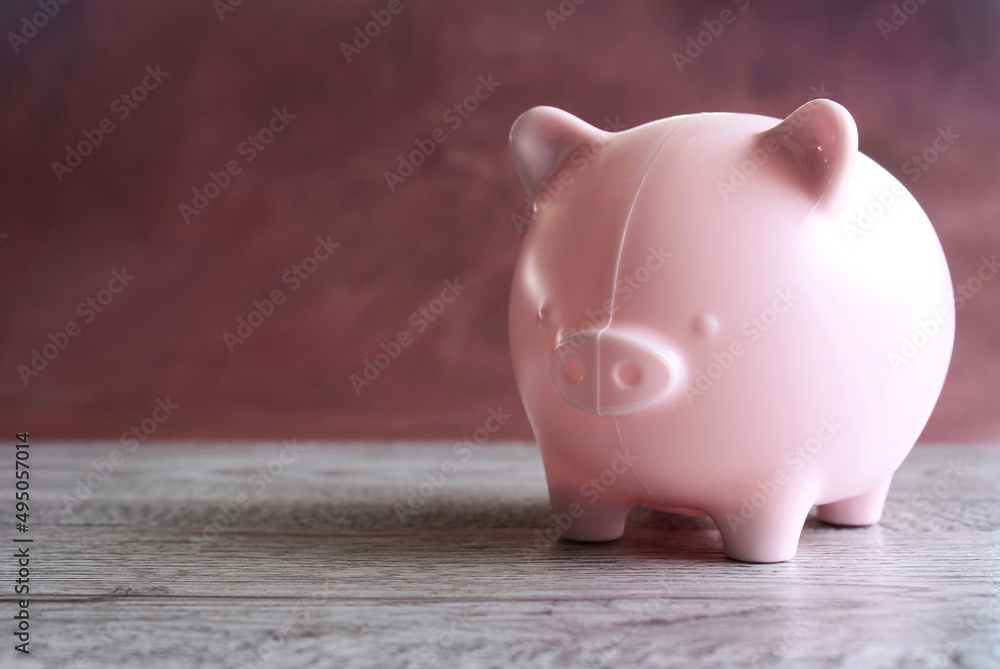 Fototapeta premium Piggy bank on table with copy space for text. Business, investment, financial planning, saving money