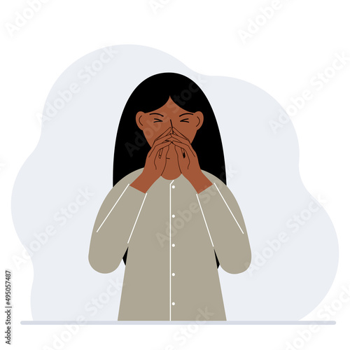 The woman covers his nose with his hands. The concept of a sick person, sneezes, seasonal allergies, bad smell.