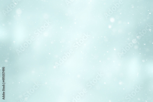 blurred snow / winter abstract background, snowflakes on abstract blurred glowing leaf background © kichigin19