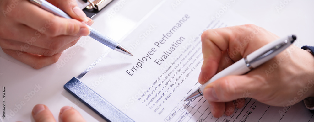 Person Filling Employee Performance Evaluation Form Person Filling Employee Performance Evaluation Form