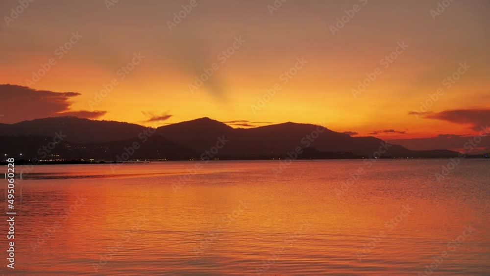 Beautiful sunset on the sea with mountains in the background. Orange tropical sunrise on the ocean against the backdrop of mountains. Dreams of Paradise Beautiful sunset on the sea with mountains in the background. Orange tropical sunrise on the ocean against the backdrop of mountains. Dreams of Paradise