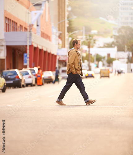 Trendy travels. Full lenth shot of a casually dressed man walking across the street.