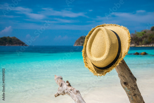 Summer hat on beautiful tropical beach white sand background in sunny day. Travel summer beach holiday concept.