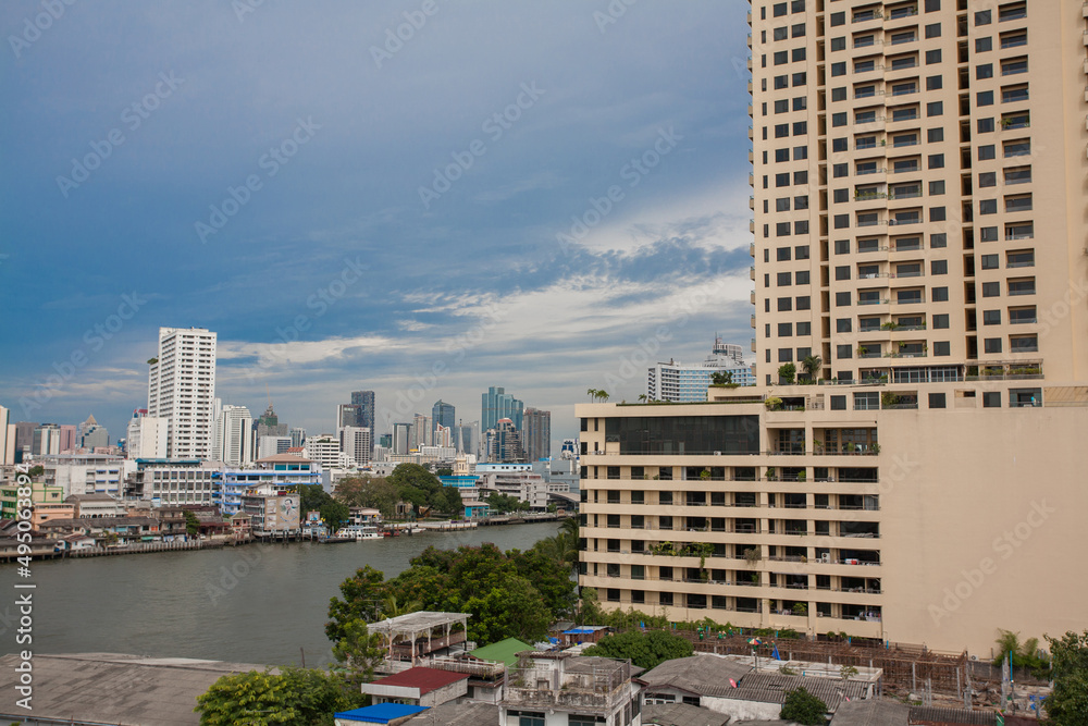 Chao Phraya River include modern tower and public boat, It's the major river in Thailand