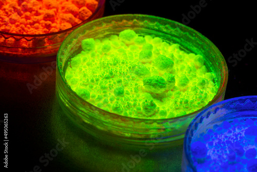 Fluorescent organic materials powder of red, yellow, green color for production OLED inside of glasses bottles in UV light.