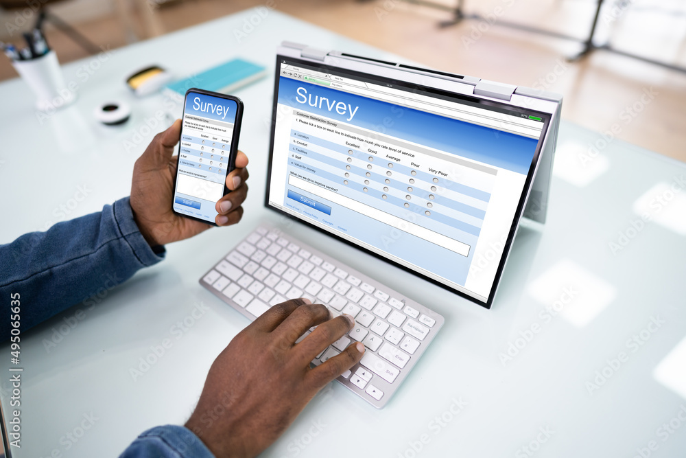 Businessman Giving Online Survey On Digital Tablet Businessman Giving Online Survey On Digital Tablet