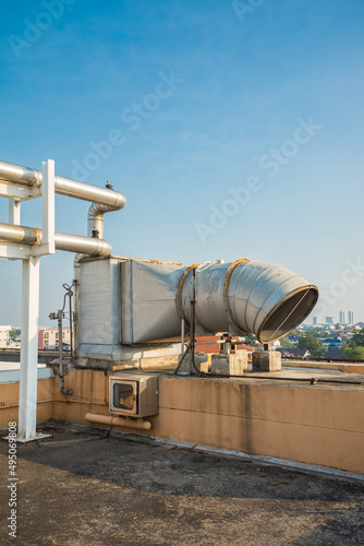 Outdoor large pipe vent ventilation on roof top of building. Ventilation system, industry and technology concept.