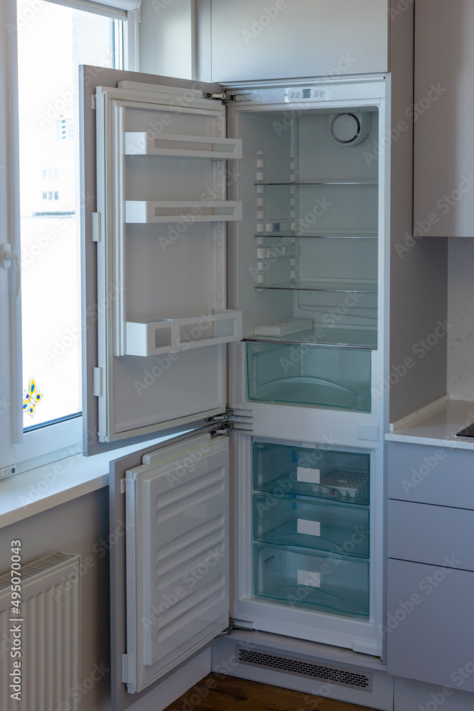 Home refrigerator with empty shelves. Lack of products.