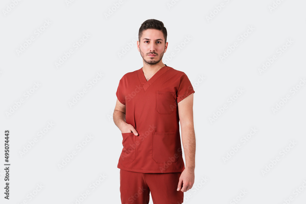 Portrait of a male doctor or nurse wearing burgundy medical uniform. Portrait of a male doctor or nurse wearing burgundy medical uniform.