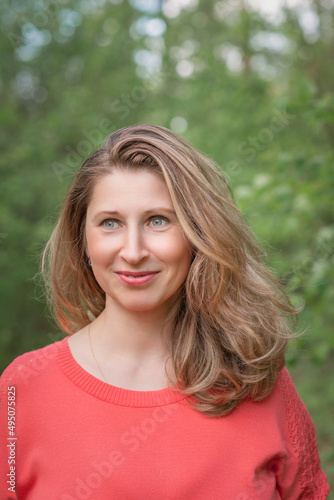 Portrait of a beautiful blonde girl in a summer field.