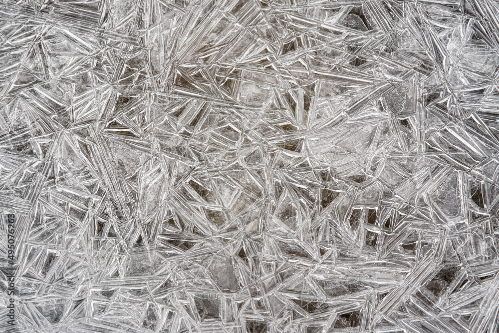 Ice on frozen river forming crystal like structures, closeup macro detail from above - abstract winter background Ice on frozen river forming crystal like structures, closeup macro detail from above - abstract winter background