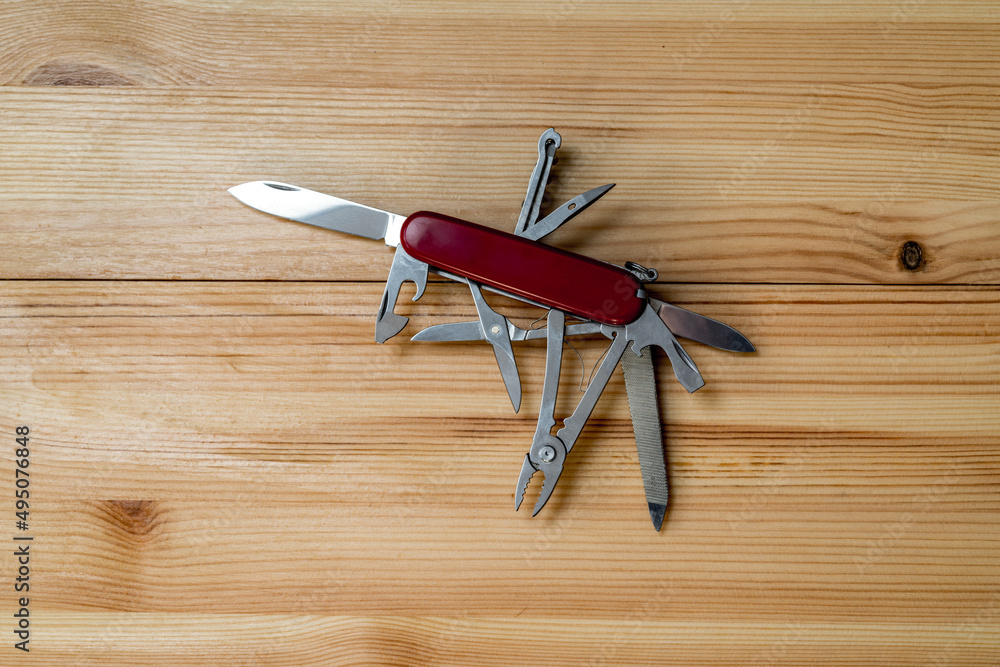 multipurpose pocket knife on wooden table