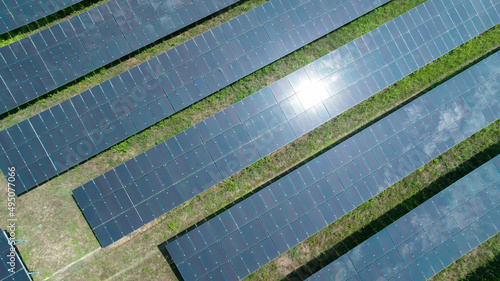 Aerial top view of solar panels or solar cells farm, renewable energy source. Ecotechnology for electric power in the industry.