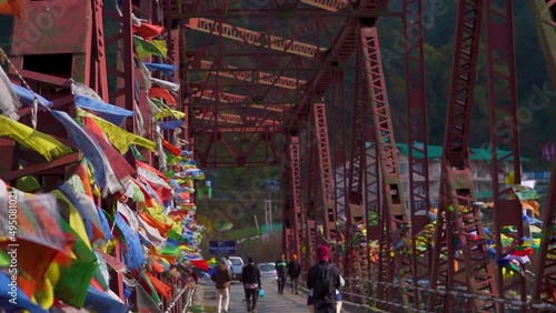 Closeup Slow motion shot of Buddhist prayer flags on a bridge waving on the wind at Manali in Himachal Pradesh, India.