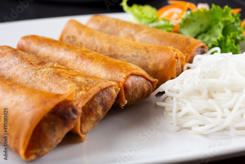A view of a plate of egg rolls.