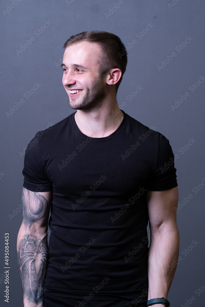 A guy standing in a black T-shirt is a beautiful sexy athlete handsome black man concept fit, for healthy model for caucasian and muscular muscle, isolated sporty. Abs grey biceps, sexy adult A guy standing in a black T-shirt is a beautiful sexy athlete handsome black man concept fit, for healthy model for caucasian and muscular muscle, isolated sporty. Abs grey biceps, sexy adult