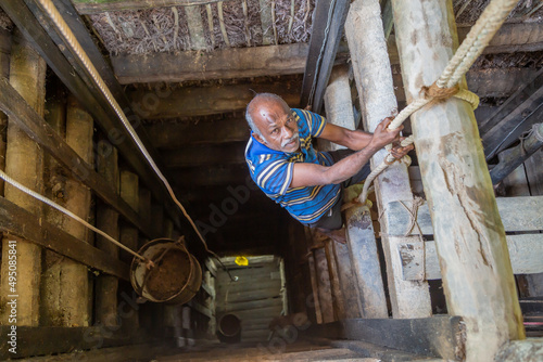 A Sri Lankan worker climbs into a mine to extract precious stones