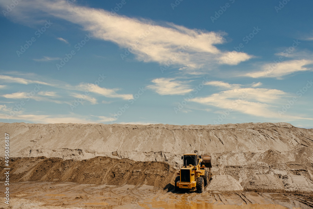 dump truck in sand quarry yellow excavator and dump truck Large piles of sand in the sandpit industry for use in construction at the construction site. dump truck in sand quarry yellow excavator and dump truck Large piles of sand in the sandpit industry for use in construction at the construction site.