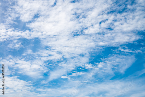 Smooth white clouds on clear blue sky background and copy space. Outdoor nature or save the earth concept.