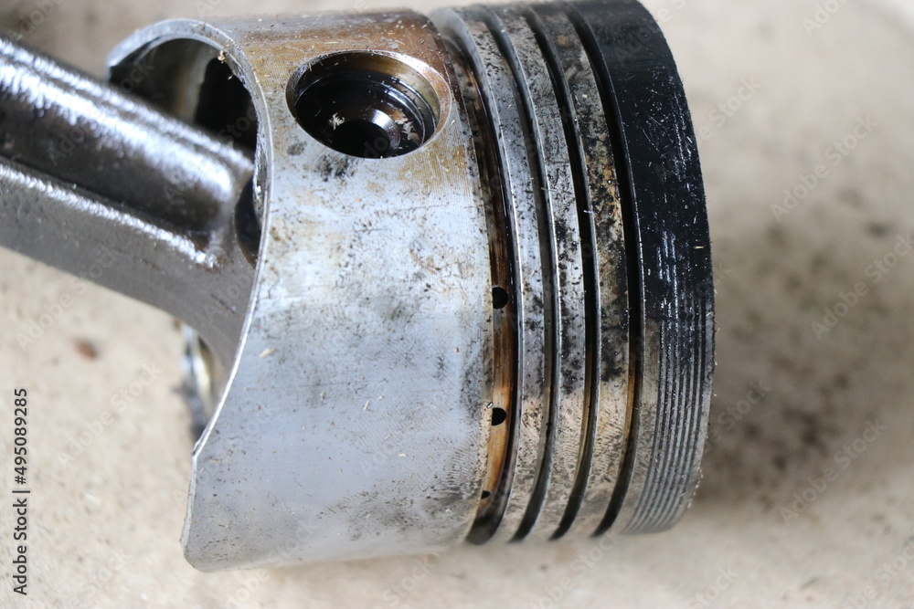 Piston from an old diesel engine with broken piston rings due to
