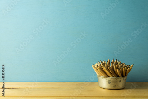 Many pencils on table over blue wooden background. Back to school  education concept.