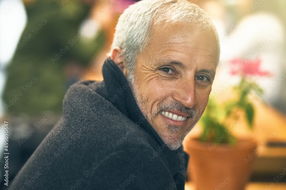 Happy to be me. Portrait of a mature man sitting inside a cafe. Happy to be me. Portrait of a mature man sitting inside a cafe.