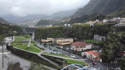 Aerial 4K drone flight over village in Madeira, Portugal with coast line and sea