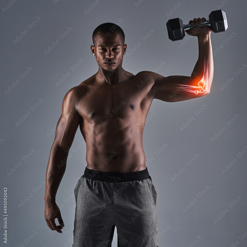 No pain, no gain. Cropped portrait of an athletic young man working up with a dumbbell.
