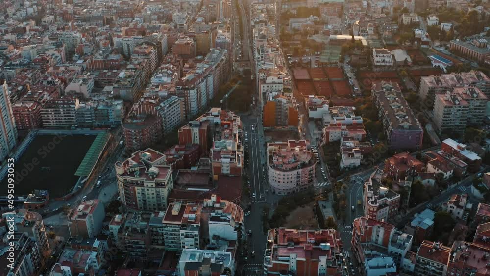 Aerial view on downtown areas at Barselona, Spain. Camera slowly moving down showing modern buildings and edifices in urban residential or business districts, intense city traffic on straight streets Aerial view on downtown areas at Barselona, Spain. Camera slowly moving down showing modern buildings and edifices in urban residential or business districts, intense city traffic on straight streets