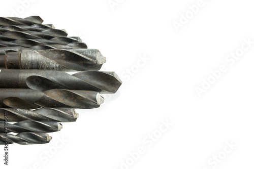 Used metal twist drill bits on white background copy space. DIY, industry equipment, hardware concept.