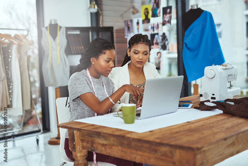 Theyre first when it comes to fashion. Cropped shot of two young fashion designers working on a laptop. Theyre first when it comes to fashion. Cropped shot of two young fashion designers working on a laptop.