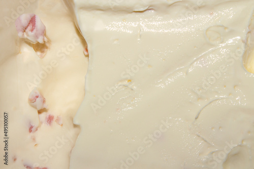 Texture of processed cheese with ham top view.Background of melted cheese.Cream cheese with ham.