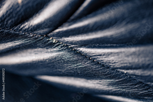 Very close up black leather sofa. Abstract view of fragment of old leather sofa.