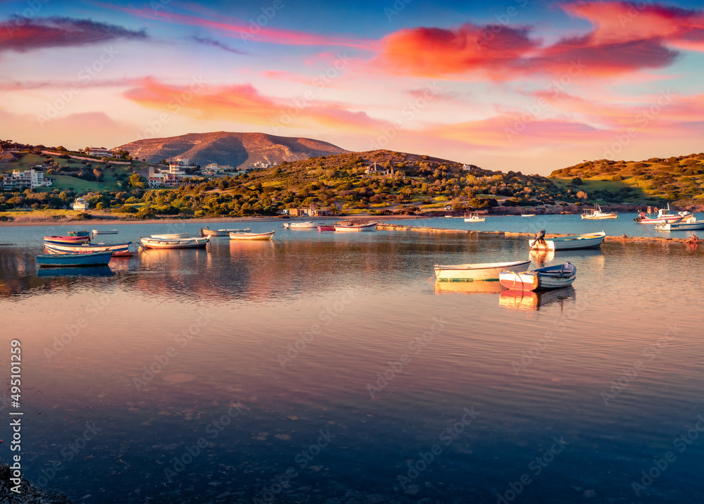 Fototapeta premium Calm summer view of Nuevo Loca Beach. Picturesque sunrise on Aegean sea. Beautiful morning scene of outskirts of Anavyssos town, Greece, Europe. Traveling concept background.