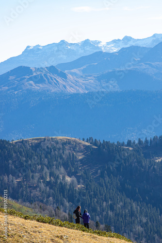 Beautiful landscape in the mountains with peaks against the blue sky and valleys covered with grass