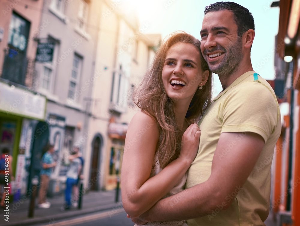 Taking their love across the world. Shot of a happy young couple sharing an affectionate moment while exploring a foreign city.