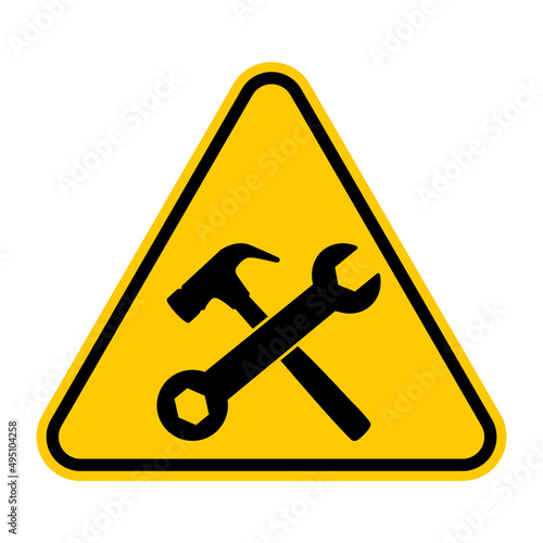 Under construction sign. Vector illustration of yellow triangle warning sign with crossed hammer and wrench icon inside. Construction site caution symbol. Risk of accident.