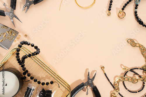 Tools and accessories for DIY jewelry in the workplace. Flat lay on beige background. Creative flat lay, concept composition. DIY craft hobby, homemade business. Making handmade for friends gifts