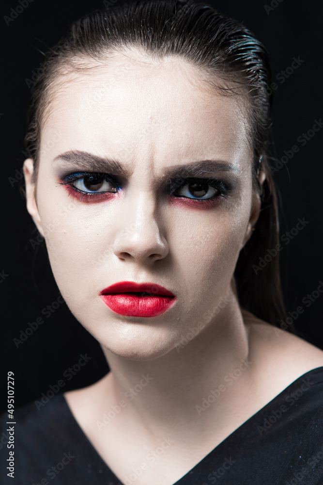 Creative Beauty Portrait with Red Lips and Blue Eyes on a Black Background Creative Beauty Portrait with Red Lips and Blue Eyes on a Black Background