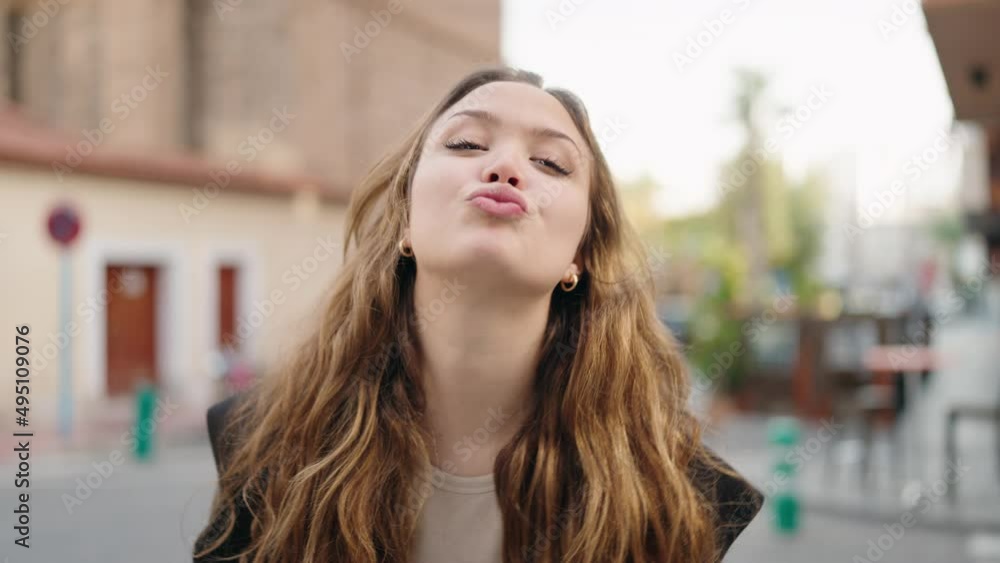 Young hispanic woman smiling confident kissing at street Young hispanic woman smiling confident kissing at street
