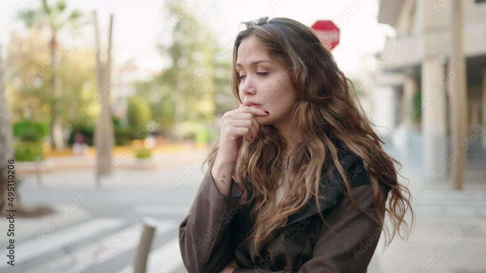 Young hispanic woman standing with worried expression at street Young hispanic woman standing with worried expression at street