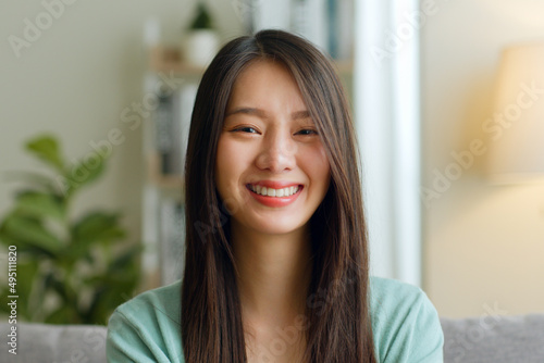 Quadro em tela Portrait of young Asian woman look at camera and smile at home.