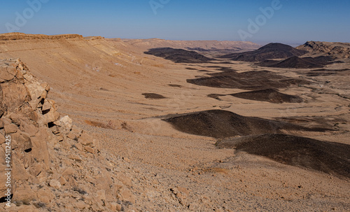 View of Ramon Crater with remanats of ancient volcanoes as seen from its most Western end as seen from Mount Ramon, located in the Negev Desert, south of Beer Sheba, Southern Israel, Israel. 